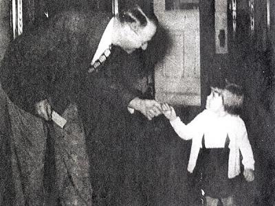 wo-year-old Alleen Petty hands CIU's first president R.C. McQuilkin a silver dollar in 1948 on the school's 25th anniversary.  